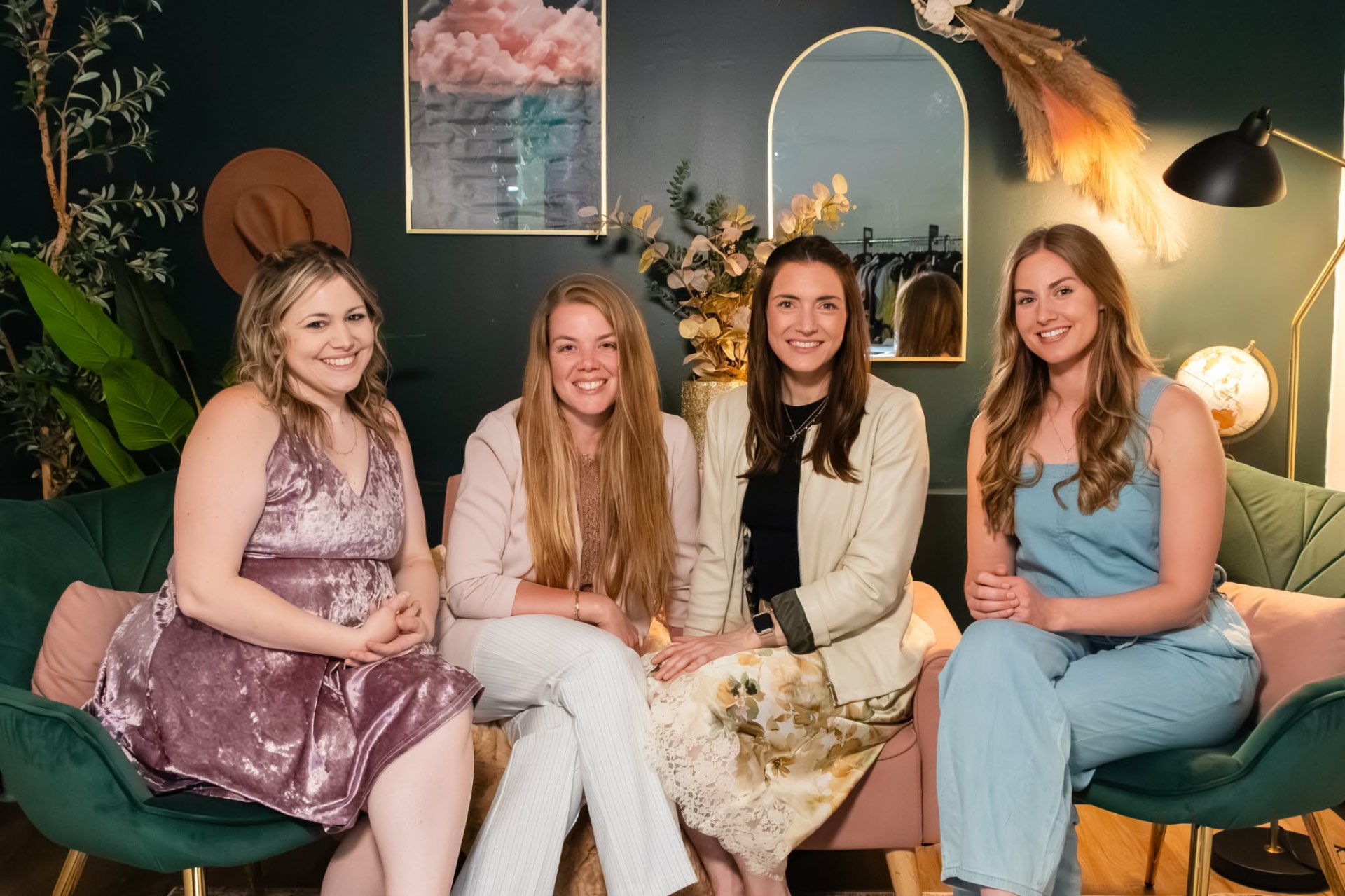 Women gathered together laughing over open Bibles and coffee